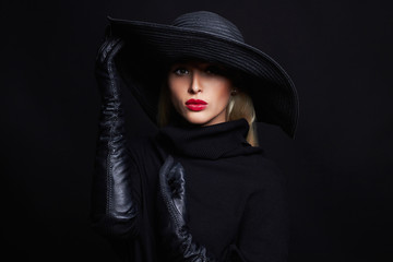Beautiful woman in hat and leather gloves.fashion model girl.halloween witch