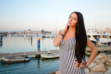Fototapeta na wymiar Beautiful attractive woman on yachts background