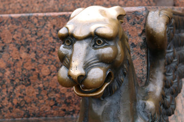 Fototapeta na wymiar Sculpture of a lion's head of brass in Russia