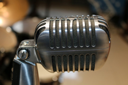 Old microphone on blurred background