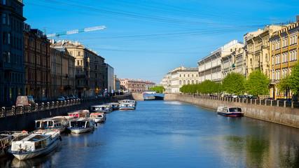 Fontanka river blue bridge and pleasure boats in Saint Petersbur