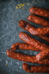 Smoked sausages on old metal background right