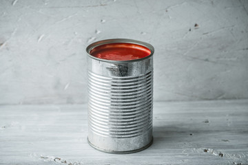 Cutting tomatoes in a tin on the blue disks