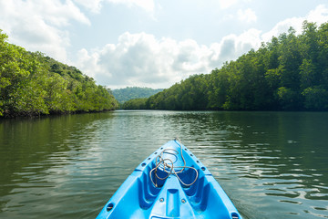 nose of canoe floating behind rower on a river