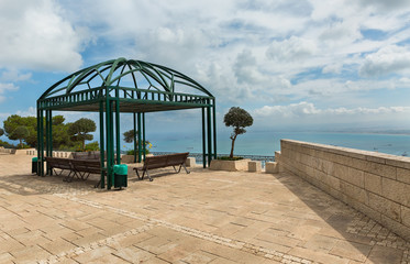 pergola with bench against a background of clouds