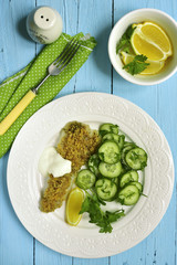 Cod baked with garlic bread crumbs garnished with cucumber salad