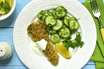 Cod baked with garlic bread crumbs garnished with cucumber salad