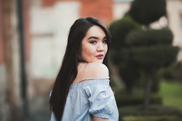 Fototapeta premium Young Asians girl with modern dress posing in an old Krakow