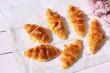 Fresh croissants on old wooden background
