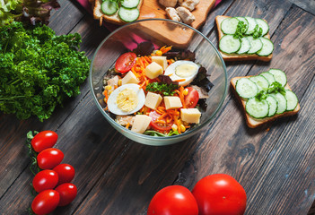 Salad with chicken, egg and tomato closeup