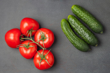 tomatoes and cucumbers and on a dark background. food concept.