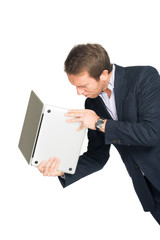 handsome man in suit angry with laptop