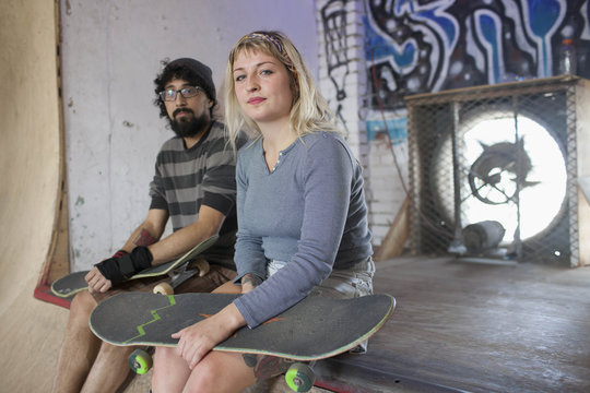 Man and woman relaxing at basement skate park