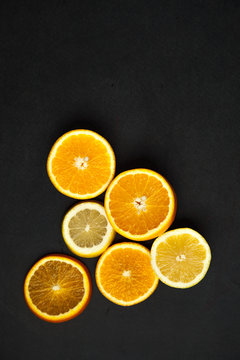 Slices of citrus on a dark background
