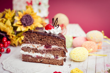 Picture close up on set of cake, colorful eggs and gift 