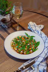 Salad with pumpkin on a wooden table