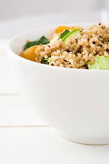 Quinoa salad in bowl on white wooden table
