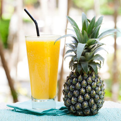Glass of pineapple smoothie, juice and fresh fruit