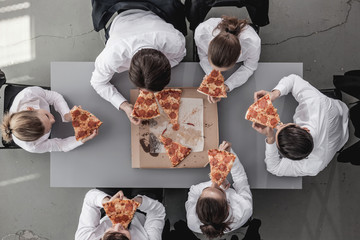 Business team eating pizza