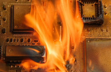 Burning circuit board with electronic components. Computer, technology, repair and fire protection...