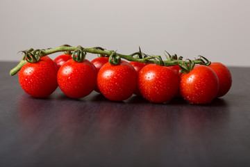 Fresh Cherry Tomatoes on Black Stone Surface