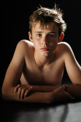 Young Shirtless Teen Boy Lying on Stomach on Floor