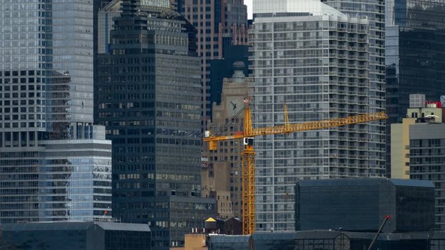 Crane Construction Time-lapse. Time-lapse on a couldy day of a crane moving and constructing a modern building in New York City.