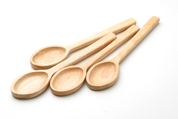  Four wooden spoons isolated on white.