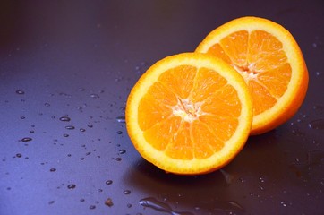 Fototapeta na wymiar Sliced orange on black background