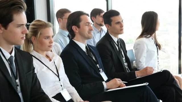 Happy business group of people clapping hands during a meeting conference