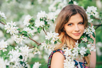 Fototapeta premium Beautiful woman in blooming garden