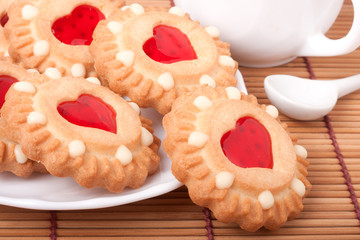 Obraz na płótnie Canvas cookie with heart jelly and cup of coffee bamboo napkin
