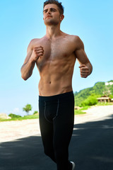 Sport. Topless Handsome Athletic Man With Fit Muscular Body In Sportswear Running On Road. Healthy Active Runner Jogging During Outdoor Workout, Exercising And Training For Marathon. Fitness Concept
