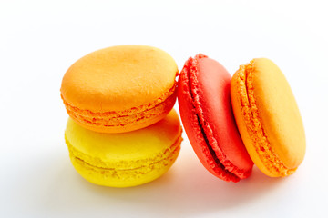pile of colorful and tasty french macaroons on white background