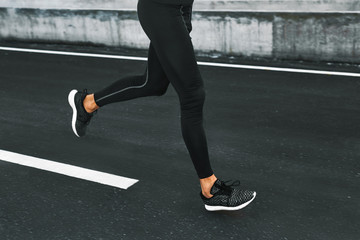 Sport. Close Up Of Sporty Male Legs In Sportwear And Sneakers Running On Road. Healthy Active Athletic Runner Man Jogging During Outdoor Workout, Exercising And Training For Marathon. Fitness Concept