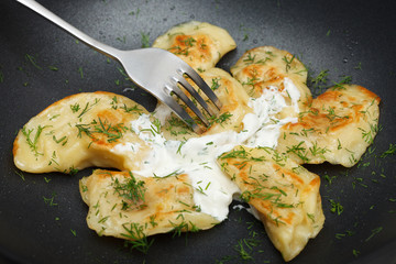 Fried dumplings with dill and sour cream