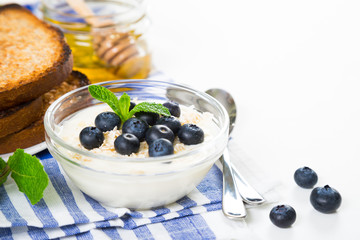 Yogurt with fresh blueberries, honey and toast, healthy breakfast