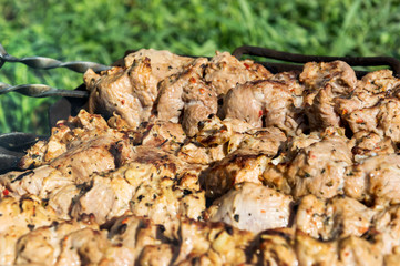 Skewers with meat roasting on grill