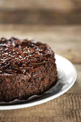 Tasty chocolate cake on wooden background