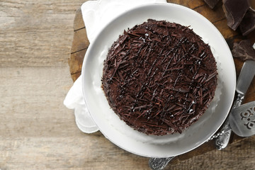 Tasty chocolate cake on wooden background