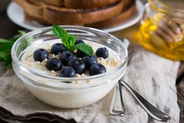 Yogurt with fresh blueberries, honey and toast, healthy breakfast