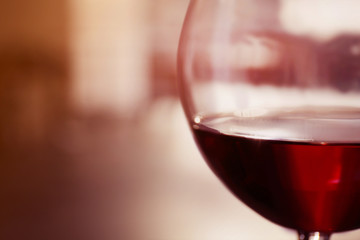Glass of red wine on blurred background