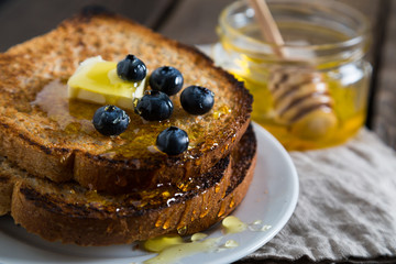 Fried toast with honey and fresh blueberries