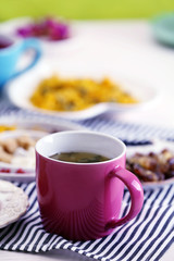 Cup of tea with aromatic dry tea on wooden background