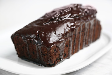 Chocolate cake with icing on white table