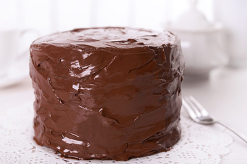 Tasty chocolate cake on light background