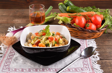 Pasta dish with black background and fresh vegetables