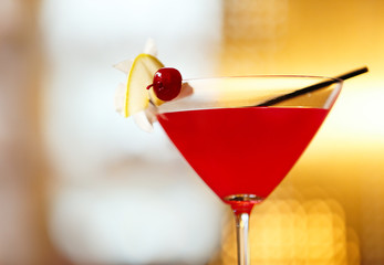 Glass of cocktail on bar background