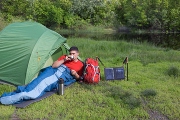The man at the campsite in the woods .