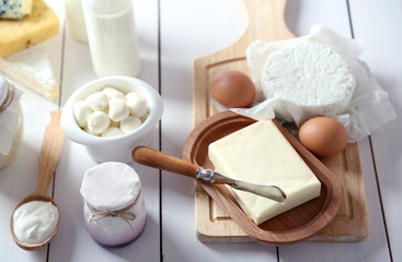 Set of fresh dairy products on white wooden table